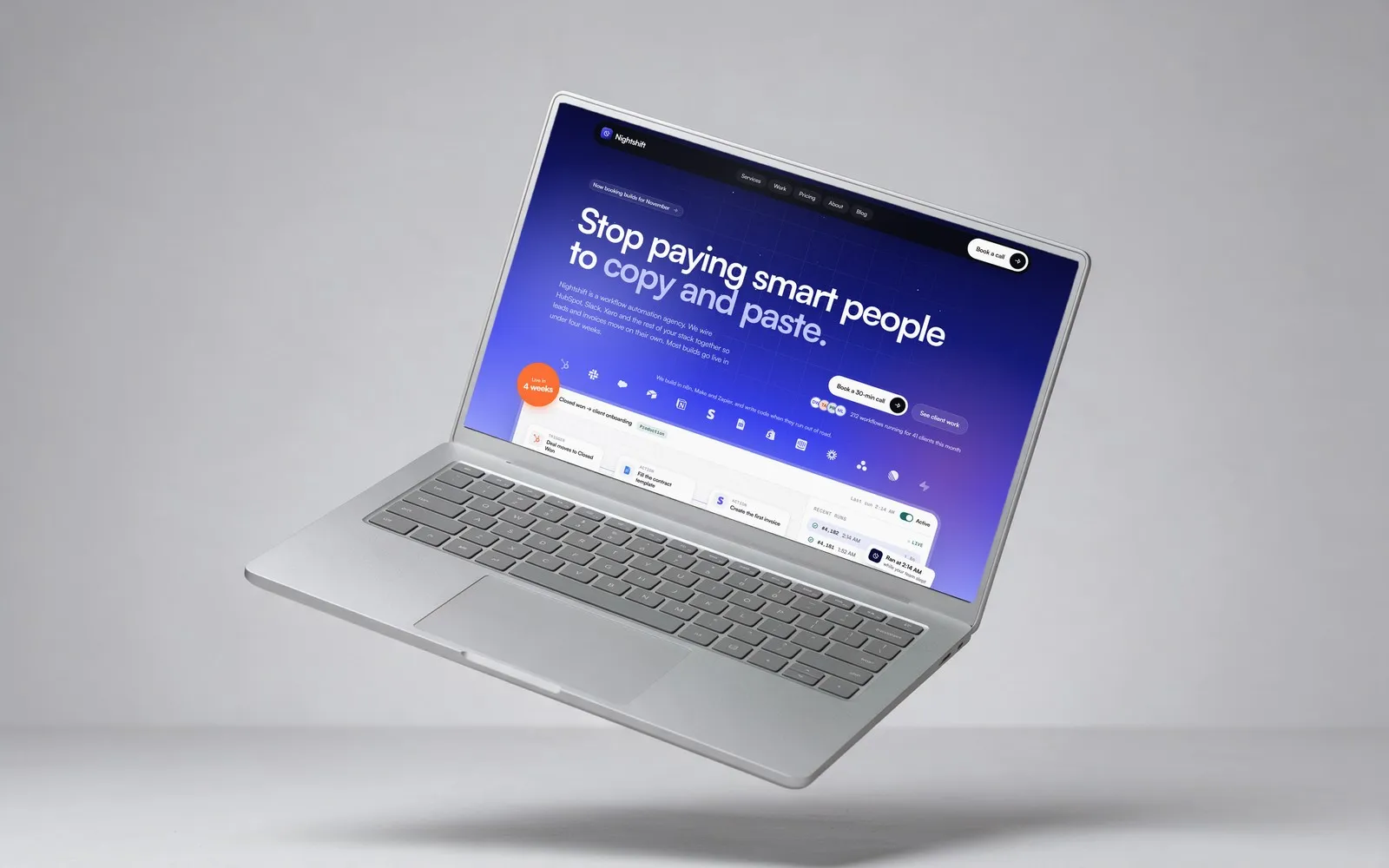 A silver laptop floating on a grey backdrop, showing the Nightshift home page